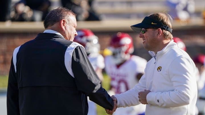 Nov 25, 2022; Columbia, Missouri, USA; Arkansas Razorbacks head coach Sam Pittman, left, shakes hands with Missouri Tigers head coach Eli Drinkwitz prior to a game at Faurot Field at Memorial Stadium. Mandatory Credit: Denny Medley-Imagn Images Nov 25, 2022; Columbia, Missouri, USA; Arkansas Razorbacks head coach Sam Pittman, left, shakes hands with Missouri Tigers head coach Eli Drinkwitz prior to a game at Faurot Field at Memorial Stadium. Mandatory Credit: Denny Medley-Imagn Images