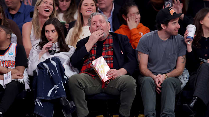 Dec 11, 2024; New York, New York, USA; New York Knicks executive chairman James Dolan eats popcorn as he sits court side during the second quarter against the Atlanta Hawks at Madison Square Garden. Mandatory Credit: Brad Penner-Imagn Images