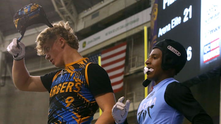 The Carroll Chargers’ Jaxx DeJean (9), left, takes off his helmet during a 7-on-7 football tournament Saturday, April 13, 2024 at the UNI Dome in Cedar Falls, Iowa.