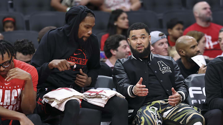 Feb 25, 2026; Houston, Texas, USA; Houston Rockets guard Fred Vanvleet (right) talks with forward Kevin Durant on the bench during the third quarter against the Sacramento Kings at Toyota Center. Mandatory Credit: Troy Taormina-Imagn Images