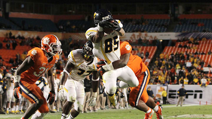 Jan 4, 2012; Miami Gardens, FL, USA; West Virginia Mountaineers wide receiver Willie Milhouse (85) dives for a touchdown during the fourth quarter of the 2012 Orange Bowl game against the Clemson Tigers at Sun Life Stadium. The Mountaineers won 70 to 33. 