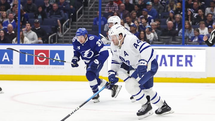 Feb 25, 2026; Tampa, Florida, USA; Toronto Maple Leafs defenseman Morgan Rielly (44) skates with the puck with Tampa Bay Lightning forward Yanni Gourde (37) behind him during the third period at Benchmark International Arena. Mandatory Credit: Morgan Tencza-Imagn Images Feb 25, 2026; Tampa, Florida, USA; Toronto Maple Leafs defenseman Morgan Rielly (44) skates with the puck with Tampa Bay Lightning forward Yanni Gourde (37) behind him during the third period at Benchmark International Arena. Mandatory Credit: Morgan Tencza-Imagn Images