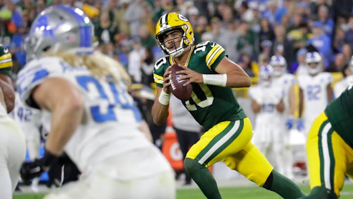Green Bay Packers quarterback Jordan Love (10) moves out of the pocket to throw a two-point pass vs. the Lions last year.