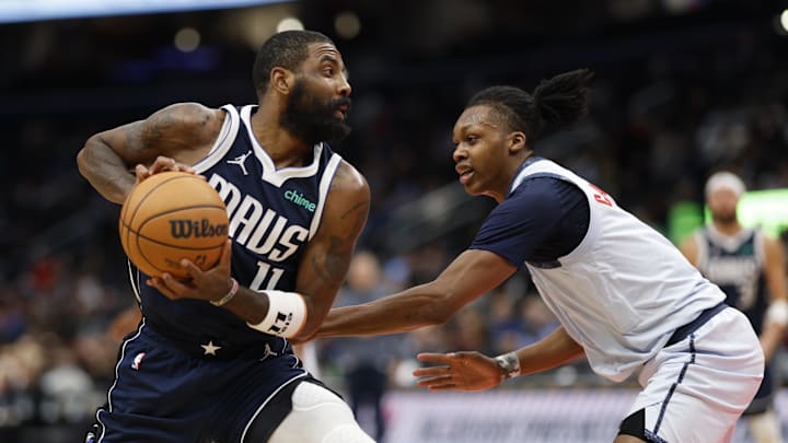 Dec 5, 2024; Washington, District of Columbia, USA; Dallas Mavericks guard Kyrie Irving (11) drives to the basket as Washington Wizards guard Bub Carrington (8) defends in the second quarter at Capital One Arena. Mandatory Credit: Geoff Burke-Imagn Images