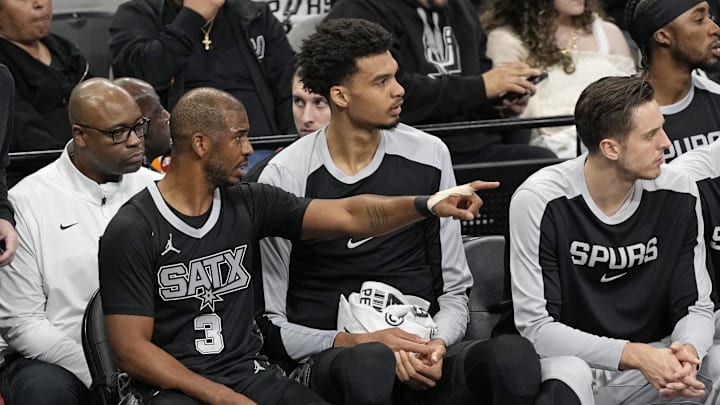 San Antonio Spurs guard Chris Paul (3) speaks with center Victor Wembanyama (1) during the first half against the Memphis Grizzlies at Frost Bank Center. 