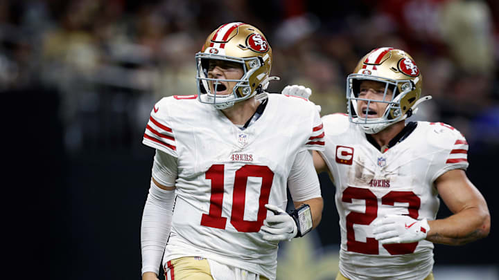 San Francisco 49ers quarterback Mac Jones (10) and running back Christian McCaffrey (23)
