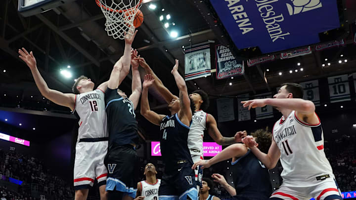 Jan 24, 2026; Storrs, Connecticut, USA; UConn Huskies center Eric Reibe (12) and forward Jaylin Stewart (3) work for the ball against Villanova Wildcats guard Tyler Perkins (4) and forward Duke Brennan (24) in the second half at Harry A. Gampel Pavilion. Mandatory Credit: David Butler II-Imagn Images