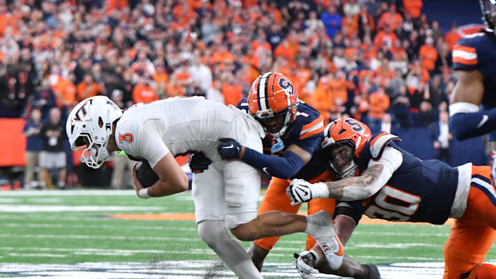 Nov 2, 2024; Syracuse, New York, USA; Syracuse Orange defensive back Jayden Bellamy (1) and defensive lineman Chase Simmons (30) make a tackle on Virginia Tech Hokies quarterback Collin Schlee (3) causing a fumble in an overtime period at JMA Wireless Dome. Mandatory Credit: Mark Konezny-Imagn Images