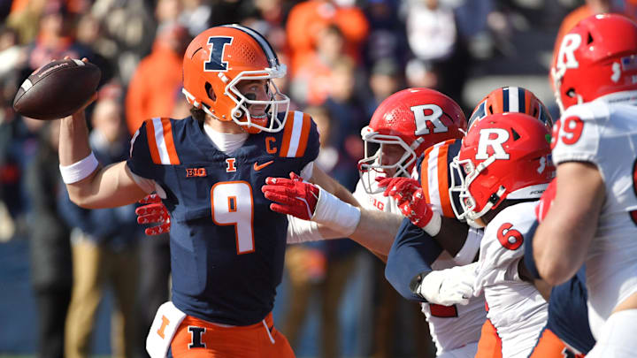 Nov 1, 2025; Champaign, Illinois, USA;  Illinois Fighting Illini quarterback Luke Altmyer (9) passes over the Rutgers Scarlet Knights line during the first half at Memorial Stadium. Mandatory Credit: Ron Johnson-Imagn Images