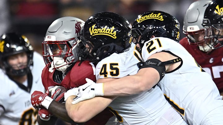 Aug 30, 2025; Pullman, Washington, USA; Washington State Cougars running back Angel Johnson (1) is tackled for a loss by Idaho Vandals defensive lineman Mitchel Jaskowiak (45) and Idaho Vandals linebacker Dylan Layne (21) in the second half at Gesa Field at Martin Stadium. Washington State Cougars won 13-10. Mandatory Credit: James Snook-Imagn Images