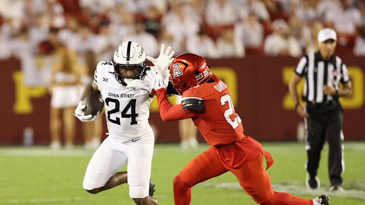 Sep 27, 2025; Ames, Iowa, USA; Iowa State Cyclones running back Abu Sama III (24) stiff arms Arizona Wildcats defensive back Michael Dansby (25) during the second half at Jack Trice Stadium. Mandatory Credit: Reese Strickland-Imagn Images