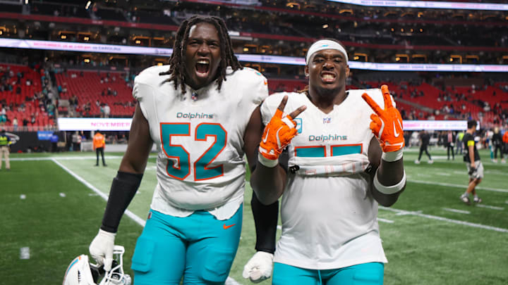 Oct 26, 2025; Atlanta, Georgia, USA; Miami Dolphins offensive tackle Patrick Paul (52) and guard Aaron Brewer (55) celebrate after a victory over the Atlanta Falcons at Mercedes-Benz Stadium. 