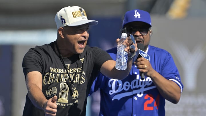Nov 1, 2024; Los Angeles, CA, USA;  Los Angeles Dodgers manager Dave Roberts (30) performs with rapper Ice Cube during the teams World Series Championship Celebration at Dodger Stadium. Mandatory Credit: Jayne Kamin-Oncea-Imagn Images