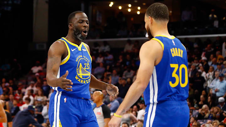 Golden State Warriors forward Draymond Green (23) reacts with guard Stephen Curry.
