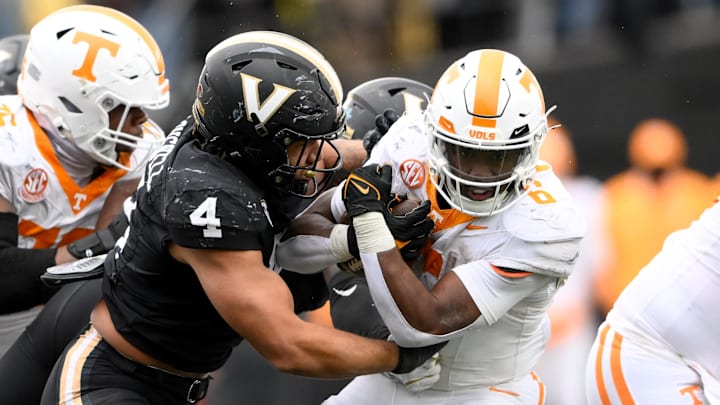 Nov 30, 2024; Nashville, Tennessee, USA;  Vanderbilt Commodores linebacker Bryan Longwell (4) tackles Tennessee Volunteers running back Dylan Sampson (6) during the second half at FirstBank Stadium. Mandatory Credit: Steve Roberts-Imagn Images