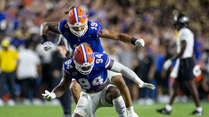 Oct 5, 2024; Gainesville, Florida, USA; Florida Gators defensive ends Tyreak Sapp (94) and T.J. Searcy (19) celebrate after a quarterback sack against the UCF Knights during the first half at Ben Hill Griffin Stadium. Mandatory Credit: Matt Pendleton-Imagn Images