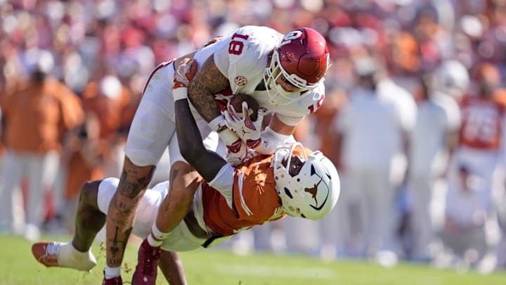 Oklahoma Sooners tight end Kaden Helms (18) looks to get by Texas Longhorns defensive back Jelani McDonald (4) in the first half of the Red River Rivalry college football game between the University of Oklahoma Sooners and the Texas Longhorn at the Cotton Bowl Stadium in Dallas, Texas, Saturday, Oct. 11, 2025.