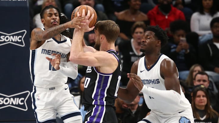  Memphis Grizzlies guard Ja Morant (12) and forward-center Jaren Jackson Jr. (13) defend Sacramento Kings forward Domantas Sabonis (10) as he drives to the basket during the second half at FedExForum. Mandatory Credit: Petre Thomas-Imagn Images