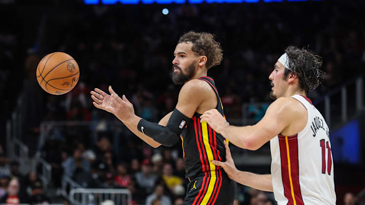 Dec 26, 2025; Atlanta, Georgia, USA; Atlanta Hawks guard Trae Young (11) makes a pass against Miami Heat forward Jaime Jaquez Jr. (11) during the fourth quarter at State Farm Arena. Mandatory Credit: Jordan Godfree-Imagn Images