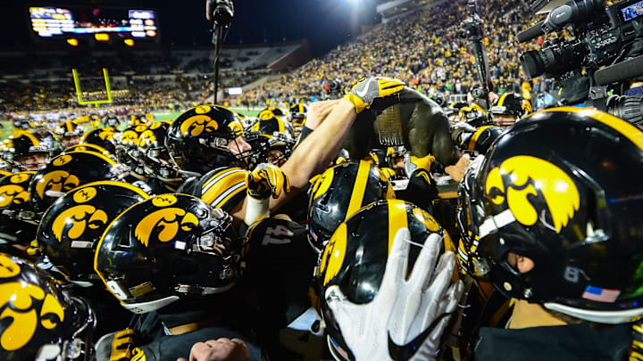 Oct 28, 2017; Iowa City, IA, USA; The Iowa Hawkeyes carry off the Floyd of Rosedale trophy after the game against the Minnesota Golden Gophers at Kinnick Stadium. Iowa won 17-10. Mandatory Credit: Jeffrey Becker-Imagn Images