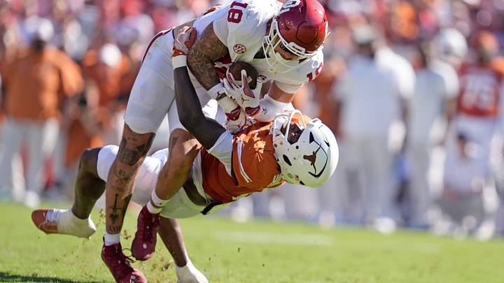Oklahoma Sooners tight end Kaden Helms (18) looks to get by Texas Longhorns defensive back Jelani McDonald (4) in the first half of the Red River Rivalry college football game between the University of Oklahoma Sooners and the Texas Longhorn at the Cotton Bowl Stadium in Dallas, Texas. Oklahoma Sooners tight end Kaden Helms (18) looks to get by Texas Longhorns defensive back Jelani McDonald (4) in the first half of the Red River Rivalry college football game between the University of Oklahoma Sooners and the Texas Longhorn at the Cotton Bowl Stadium in Dallas, Texas.