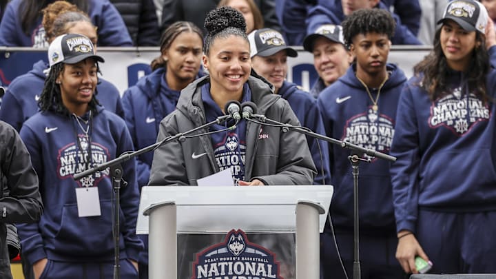Apr 13, 2025; Hartford, CT, USA;   UConn student-athlete Azzi Fudd addresses the crowd while her teammates UConn student-athletes Paige Bueckers,  KK Arnold, Sarah Strong  and Ayanna Patterson look on during the Final Four champions victory parade and rally outside of the XL Center in Hartford, CT. Mandatory Credit: Scott Rausenberger-Imagn Images