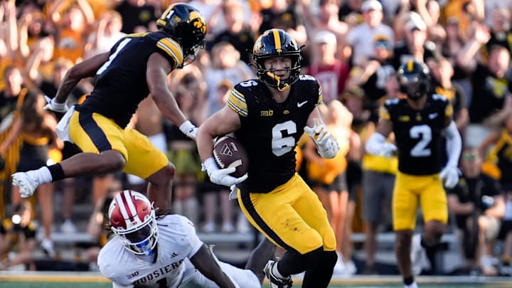 Iowa Hawkeyes defensive back Zach Lutmer (6) runs with the ball after intercepting a pass by Indiana Hoosiers quarterback Fernando Mendoza (15) Sept. 27, 2025 at Kinnick Stadium in Iowa City, Iowa.