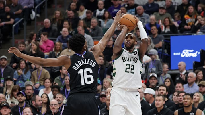 Milwaukee Bucks forward Khris Middleton (22) shoots the ball over Utah Jazz guard Elijah Harkless (16) during the second quarter at Delta Center on Monday.