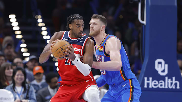 Oct 30, 2025; Oklahoma City, Oklahoma, USA; Washington Wizards center Alex Sarr (20) moves the ball as Oklahoma City Thunder center Isaiah Hartenstein (55) defends during the second half at Paycom Center. Mandatory Credit: Alonzo Adams-Imagn Images