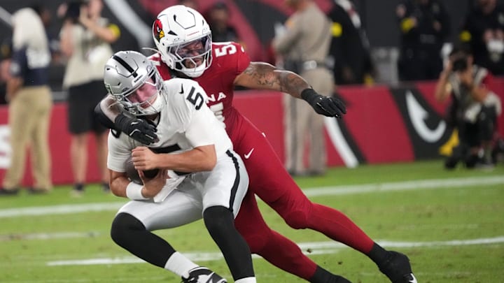Arizona Cardinals linebacker Xavier Thomas (54) tackles Las Vegas Raiders quarterback Cam Miller (5) at State Farm Stadium in Glendale, on Aug. 23, 2025. Arizona Cardinals linebacker Xavier Thomas (54) tackles Las Vegas Raiders quarterback Cam Miller (5) at State Farm Stadium in Glendale, on Aug. 23, 2025.