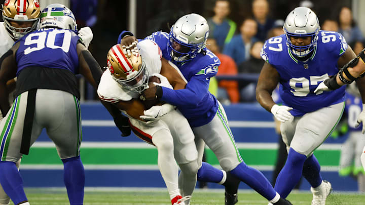Oct 10, 2024; Seattle, Washington, USA; Seattle Seahawks linebacker Jerome Baker (17) tackles San Francisco 49ers wide receiver Brandon Aiyuk (11) during the second quarter at Lumen Field. Mandatory Credit: Joe Nicholson-Imagn Images