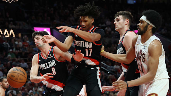 Mar 25, 2025; Portland, Oregon, USA: Portland Trail Blazers forward Deni Avdija (8), guard Shaedon Sharpe (17), center Donovan Clingan (23) and Cleveland Cavaliers center Jarrett Allen (31) fight for a loose ball in the first half at Moda Center. Mandatory Credit: Jaime Valdez-Imagn Images