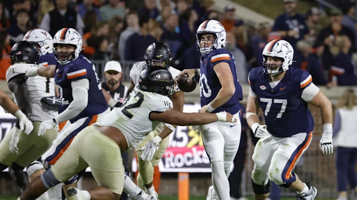 Nov 8, 2025; Charlottesville, Virginia, USA; Virginia Cavaliers quarterback Daniel Kaelin (10) is sacked by Wake Forest Demon Deacons defensive lineman Dallas Afalava (52) to fumble the ball for an overturn during the first half at Scott Stadium. Mandatory Credit: Amber Searls-Imagn Images