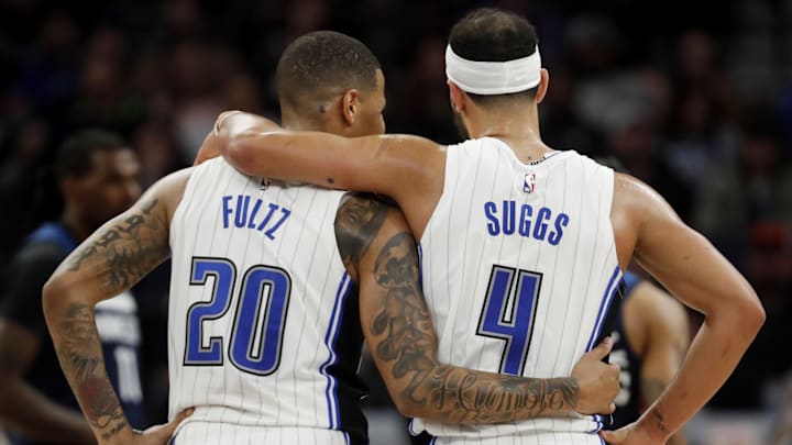 Orlando Magic guard Markelle Fultz (20) hugs guard Jalen Suggs (4) as the Minnesota Timberwolves shoot free throws in the third quarter at Target Center.