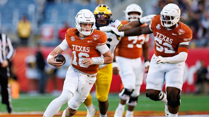 Texas quarterback Arch Manning (16) runs with the ball against Michigan at Camping World Stadium. Mandatory Credit: Matt Pendleton-Imagn Images