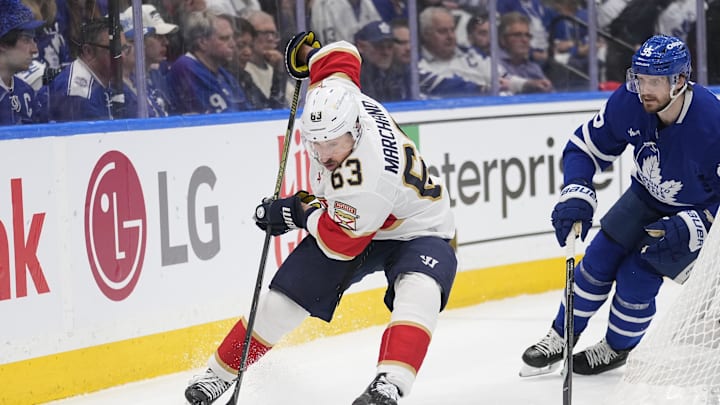 May 18, 2025; Toronto, Ontario, CAN; Florida Panthers forward Brad Marchand (63) controls the puck against Toronto Maple Leafs defenceman Oliver Ekman-Larsson (95) during the second period of game seven of the second round of the 2025 Stanley Cup Playoffs at Scotiabank Arena. Mandatory Credit: John E. Sokolowski-Imagn Images