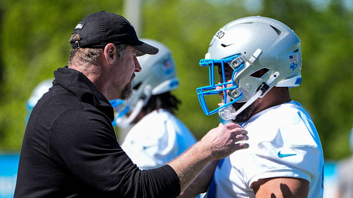 Detroit Lions head coach Dan Campbell talks to defensive lineman Breiden Fehoko (76) during rookie mini camp at Meijer Performance Center in Allen Park on Friday, May 9, 2025.