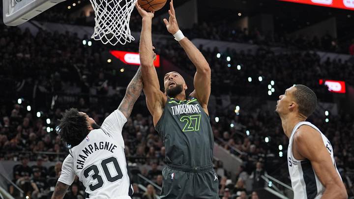 May 6, 2026; San Antonio, Texas, USA; Minnesota Timberwolves center Rudy Gobert (27) shoots over San Antonio Spurs forward Julian Champagnie (30) in the first half during game two of the second round of the 2026 NBA Playoffs at Frost Bank Center. Mandatory Credit: Daniel Dunn-Imagn Images