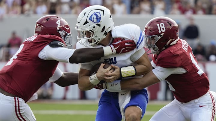 Nov 22, 2025; Tuscaloosa, Alabama, USA; Eastern Illinois quarterback Cole LaCrue (3) is tackled by Alabama linebacker Qua Russaw (4) and Alabama defensive back Bray Hubbard (18) at Saban Field at Bryant-Denny Stadium. Mandatory Credit: Gary Cosby Jr.-Imagn Images Nov 22, 2025; Tuscaloosa, Alabama, USA; Eastern Illinois quarterback Cole LaCrue (3) is tackled by Alabama linebacker Qua Russaw (4) and Alabama defensive back Bray Hubbard (18) at Saban Field at Bryant-Denny Stadium. Mandatory Credit: Gary Cosby Jr.-Imagn Images
