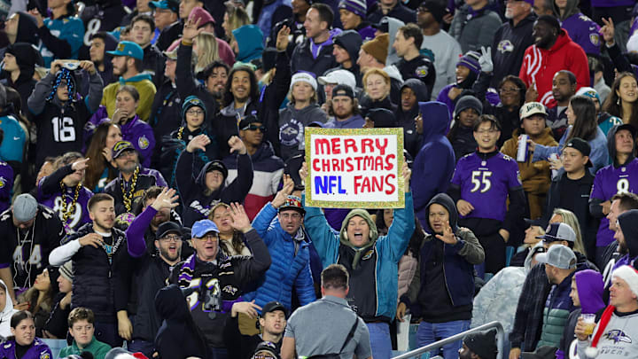 Fans watch with a Merry Christmas sign during a game between the Baltimore Ravens and Jacksonville Jaguars. Fans watch with a Merry Christmas sign during a game between the Baltimore Ravens and Jacksonville Jaguars.
