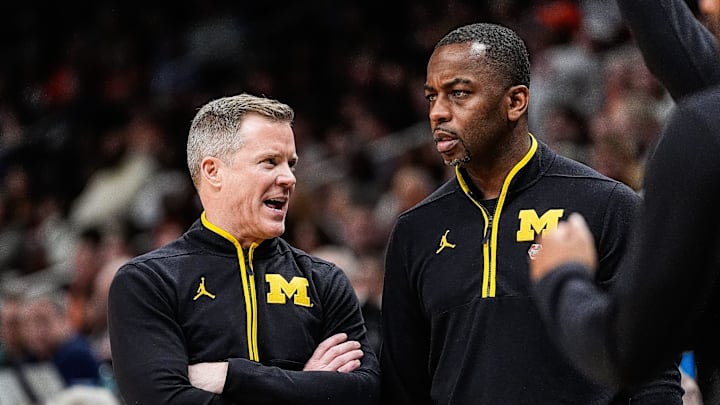 Michigan head coach Dusty May talks to assistant coach Mike Boynton Jr. during the second half of the Sweet 16 round of NCAA tournament at State Farm Arena in Atlanta, Ga. on Friday, March 28, 2025.