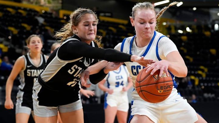 Mount Vernon's Taylor Franck (11) and Clear Creek Amana's Lena Evans (15) reach for the basketball during a girls basketball game Tuesday, Feb. 11, 2025 at Xtream Arena in Coralville, Iowa.