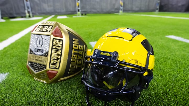 Jan 8, 2024; Houston, TX, USA; Detailed view of a Michigan Wolverines helmet and an oversized championship ring after defeating the Washington Huskies during the 2024 College Football Playoff national championship game at NRG Stadium. Mandatory Credit: Mark J. Rebilas-Imagn Images