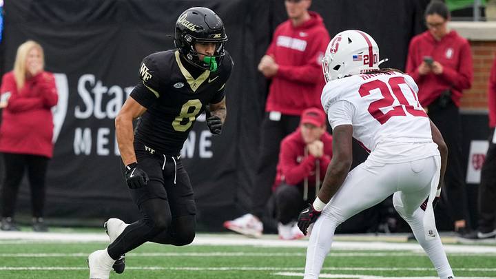 Oct 3, 2026; Winston-Salem, North Carolina, USA;  Wake Forest Demon Deacons wide receiver Carlos Hernandez (8) takes off on his route against Stanford Cardinal cornerback Xavier Harmon (20) during the second half at Allegacy Federal Credit Union Stadium.  Mandatory Credit: Jim Dedmon-Imagn Images
