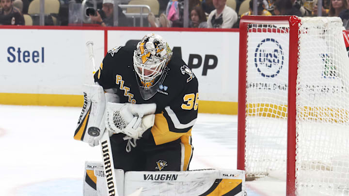 Mar 18, 2025; Pittsburgh, Pennsylvania, USA;  Pittsburgh Penguins goaltender Tristan Jarry (35) makes a save against the New York Islanders during the second period at PPG Paints Arena. Mandatory Credit: Charles LeClaire-Imagn Images