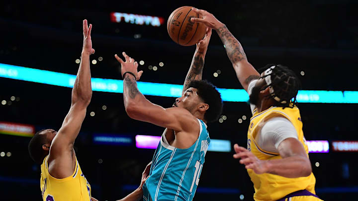 Nov 8, 2021; Los Angeles, California, USA; Los Angeles Lakers guard Avery Bradley (20) and forward Anthony Davis (3) defends against Charlotte Hornets center Nick Richards (14) during the first half at Staples Center. Mandatory Credit: Gary A. Vasquez-Imagn Images