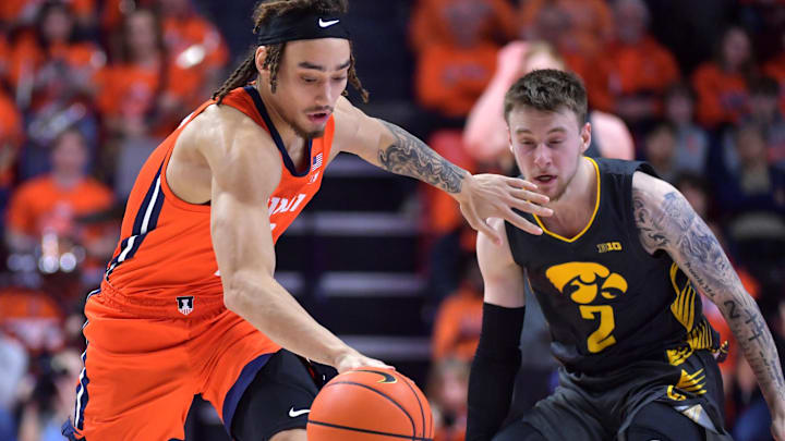 Feb 25, 2025; Champaign, Illinois, USA;  Illinois Fighting Illini guard Dra Gibbs-Lawhorn (2) drives the ball as Iowa Hawkeyes guard Brock Harding (2) defends during the second half at State Farm Center. Mandatory Credit: Ron Johnson-Imagn Images