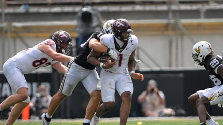 Aug 31, 2024; Nashville, Tennessee, USA; Virginia Tech Hokies quarterback Kyron Drones (1) gets tackled from behind by Vanderbilt Commodores linebacker Langston Patterson (10) during the second half at FirstBank Stadium. Mandatory Credit: Steve Roberts-Imagn Images Aug 31, 2024; Nashville, Tennessee, USA; Virginia Tech Hokies quarterback Kyron Drones (1) gets tackled from behind by Vanderbilt Commodores linebacker Langston Patterson (10) during the second half at FirstBank Stadium. Mandatory Credit: Steve Roberts-Imagn Images