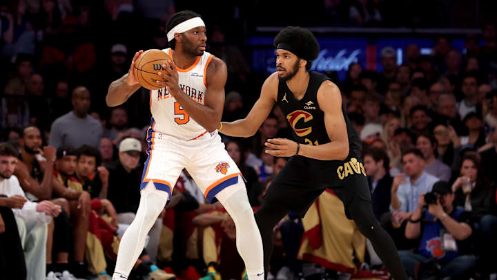 New York Knicks forward Precious Achiuwa controls the ball against Cleveland Cavaliers center Jarrett Allen. Mandatory Credit: Brad Penner-Imagn Images