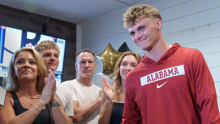 Dunlap senior and four-star college football recruit Mack Sutter, right, stands with his family after announcing his commitment to play football at the University of Alabama during a gathering Thursday, June 26, 2025 at Weaver's Fresh Food & Drink in Peoria.